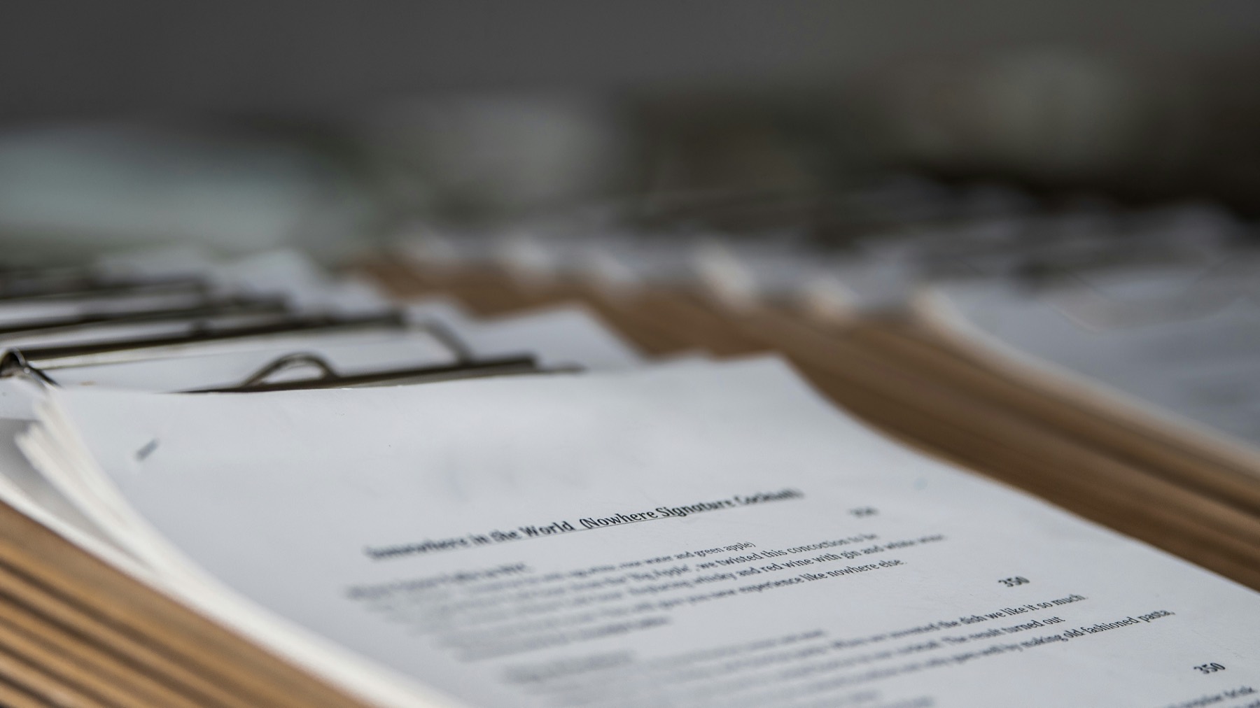 Stacks of documents on clipboards, rendered in deep shadow