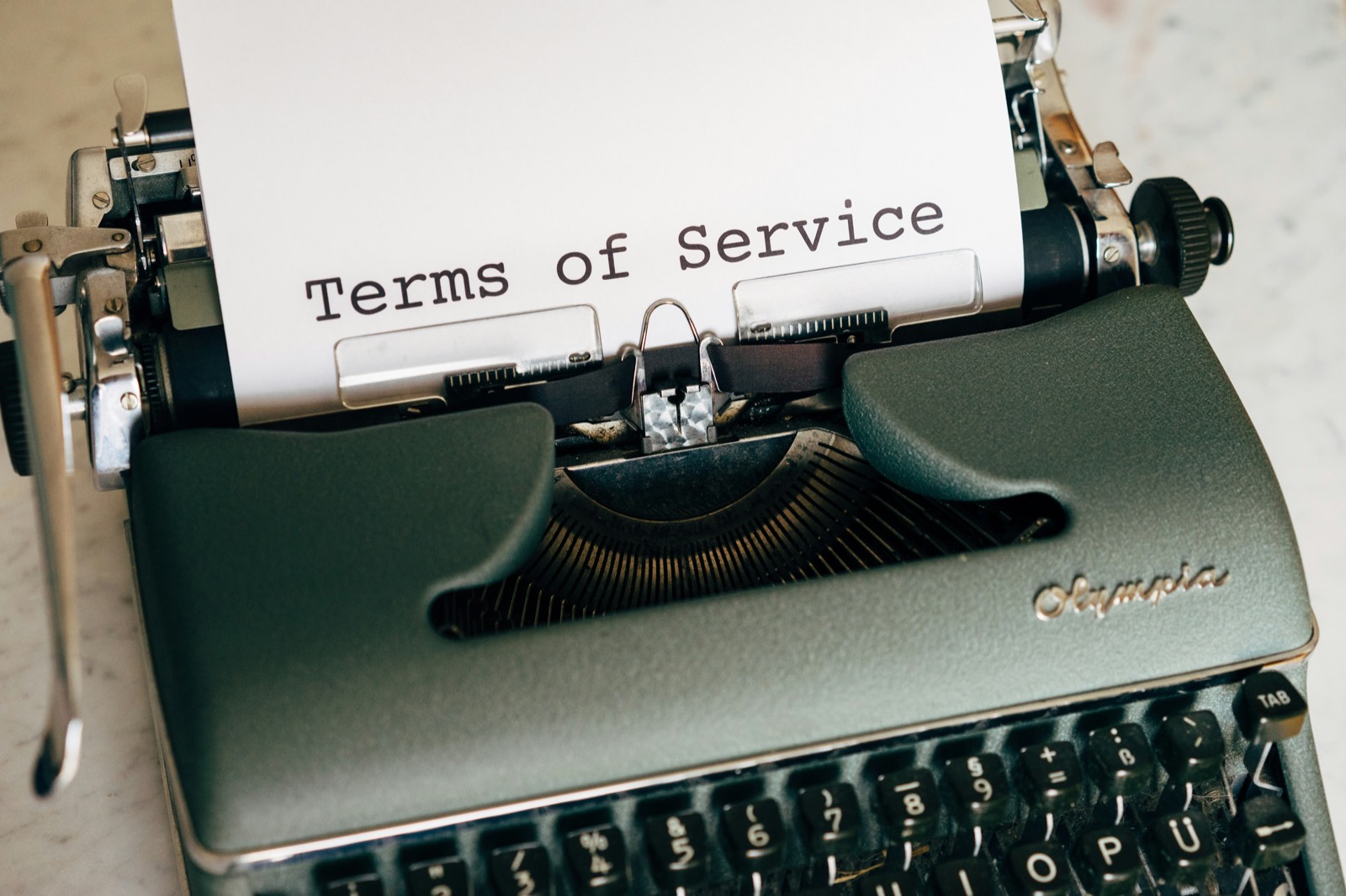 A vintage typewriter with a sheet reading Terms of Service